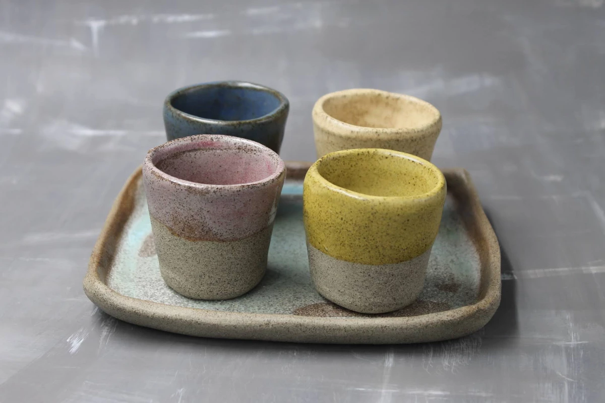 Set of ceramic espresso shots with tray