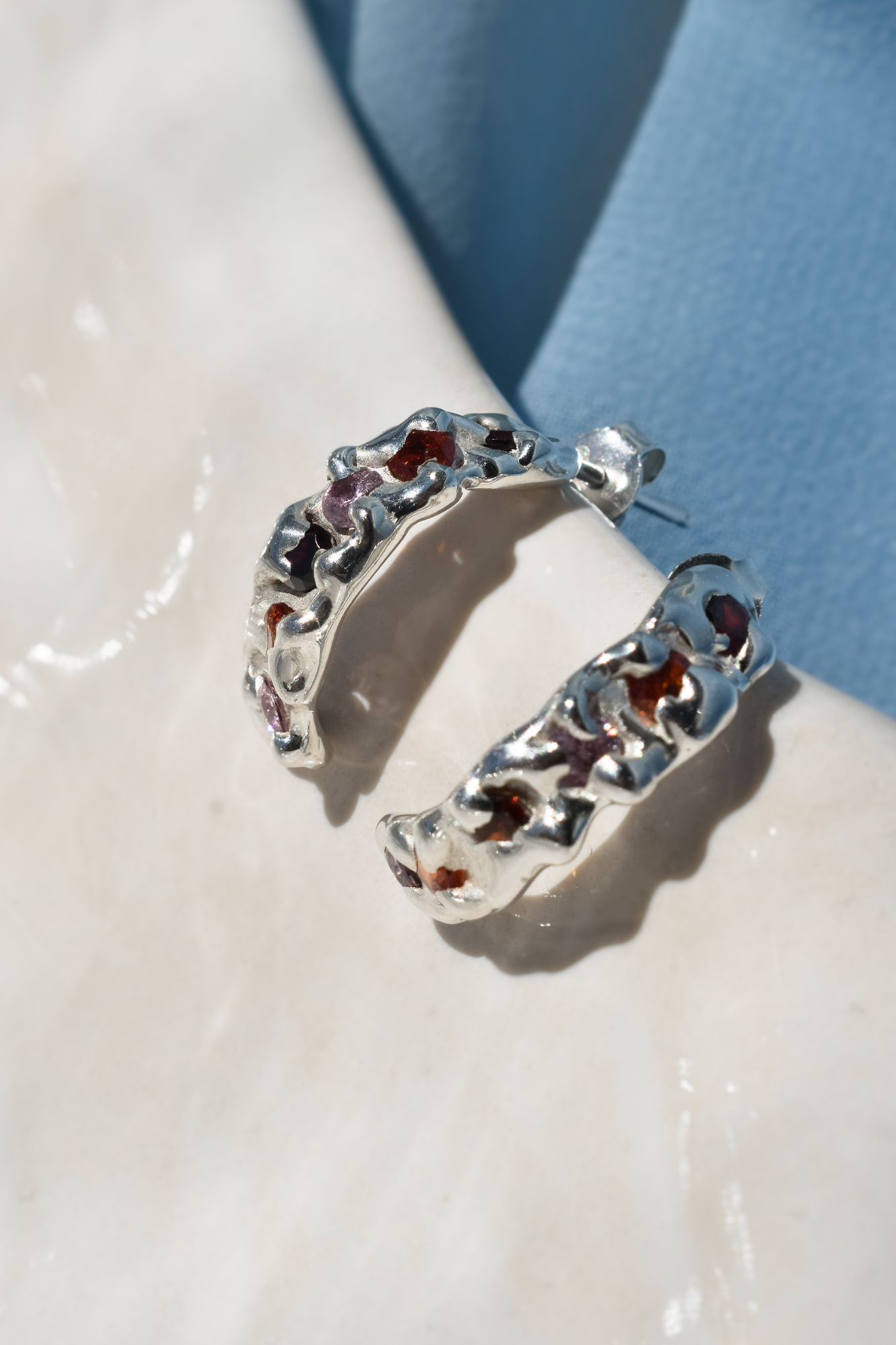 Silver molten textured hoop earrings with cubic zirconias