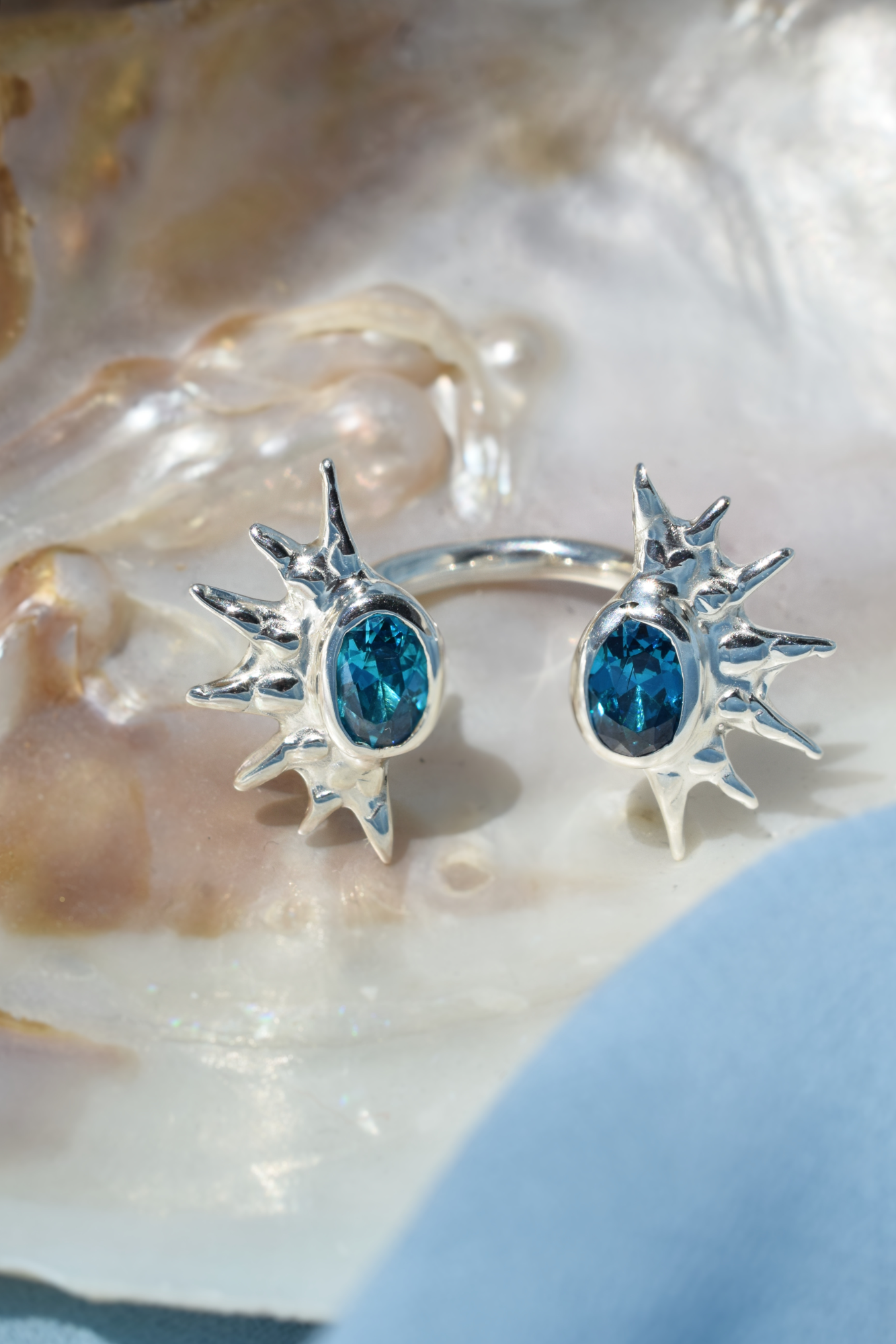 Cuff ring with vibrant blue oval stones