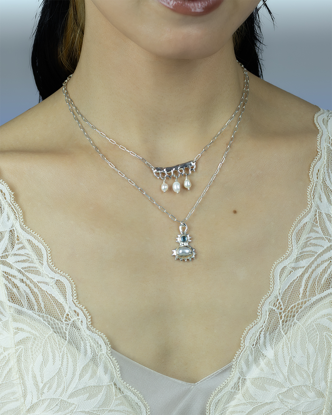Coral inspired pendant with a blue topaz and a fresh water pearl