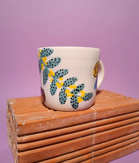 Floral ceramic mug with cute face