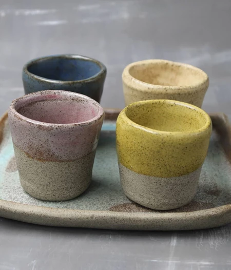 Set of ceramic espresso shots with tray