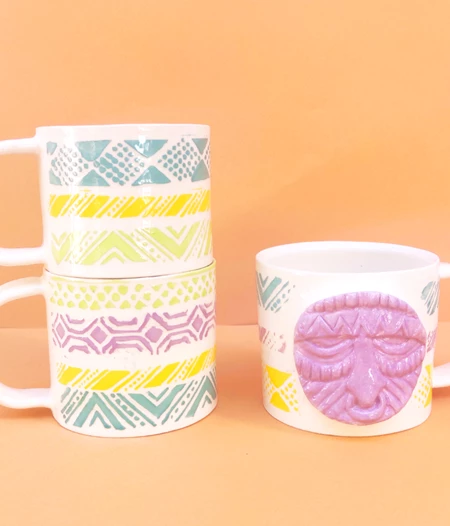 Handmade ceramic mug with colourful patterns