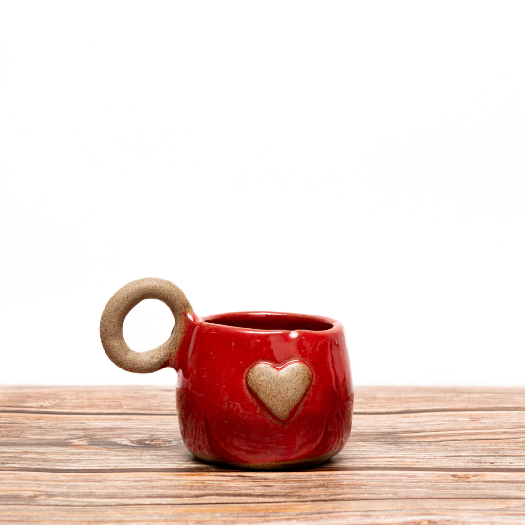 Handmade ceramic cup for tea full in love